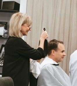 Elena, barber at Urban Philosophy performing a haircut in Toronto